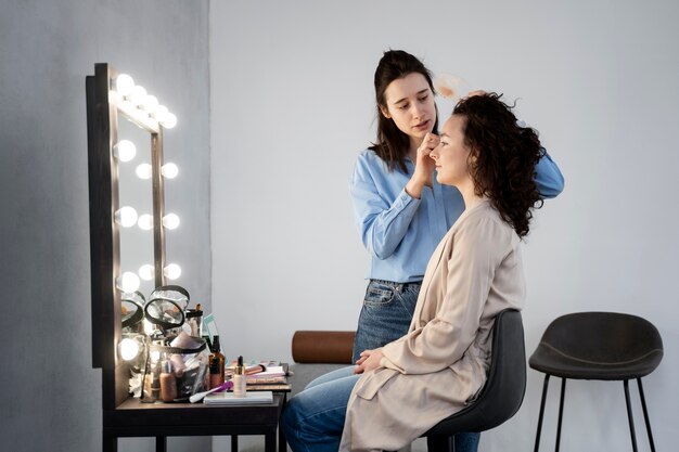 Maquilladora preparando modelo para sesión de fotos