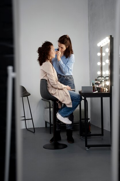 Maquilladora preparando modelo para sesión de fotos