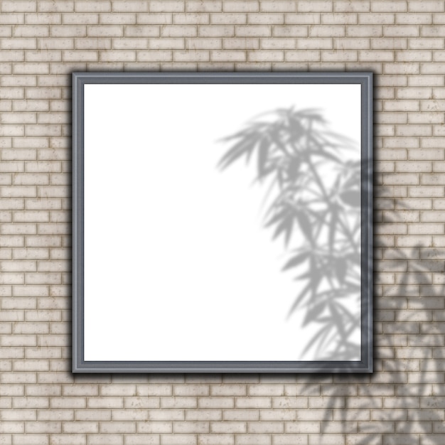 Marco en blanco en la pared de ladrillo con superposición de sombra de planta