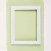 Foto gratuita marco de borde rectangular blanco sobre papel verde menta sobre fondo blanco