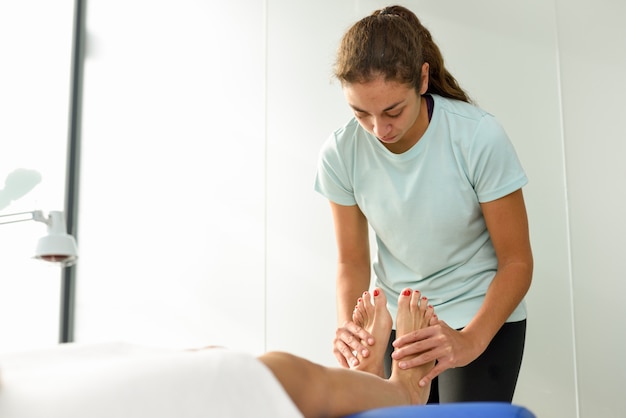 Masaje médico al pie en un centro de fisioterapia.