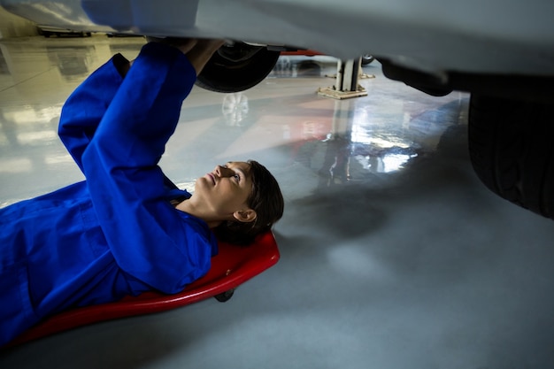 Mecánico de sexo femenino que repara un coche