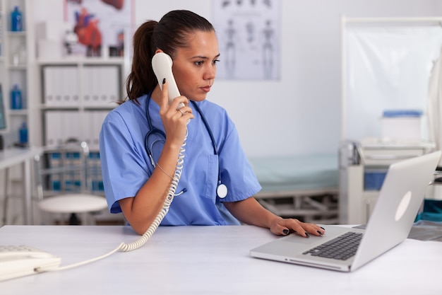 Médico contestando llamadas telefónicas