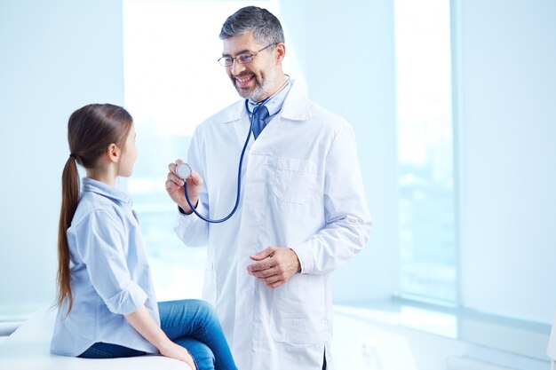 Médico examinando a su joven paciente