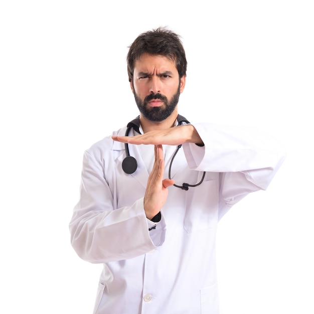 Médico haciendo tiempo gesto sobre fondo blanco