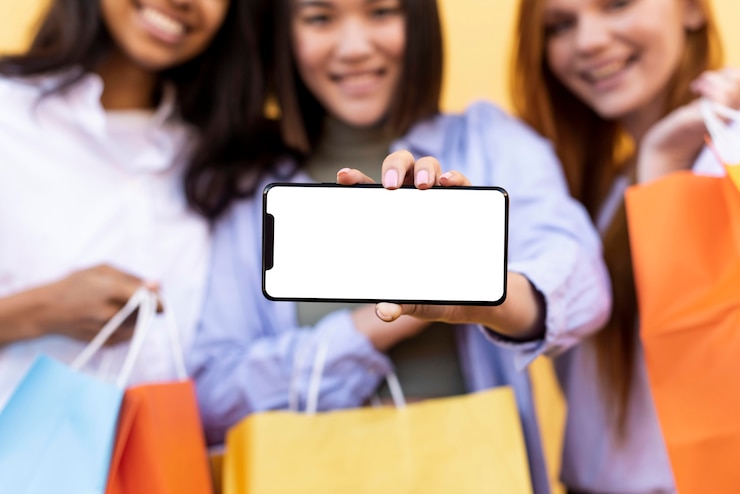 Foto gratuito mejores amigos con bolsas de la compra y un teléfono en blanco