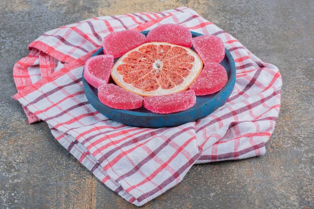 Mermelada con rodaja de pomelo sobre un mantel. Foto de alta calidad