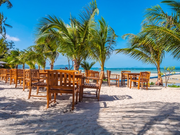 Mesa y silla de madera en la playa.