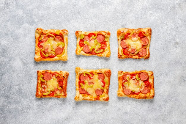 Mini pizzas de hojaldre con salchichas.