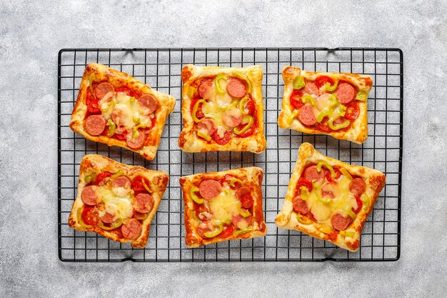 Mini pizzas de hojaldre con salchichas.