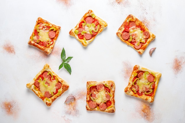 Mini pizzas de hojaldre con salchichas.