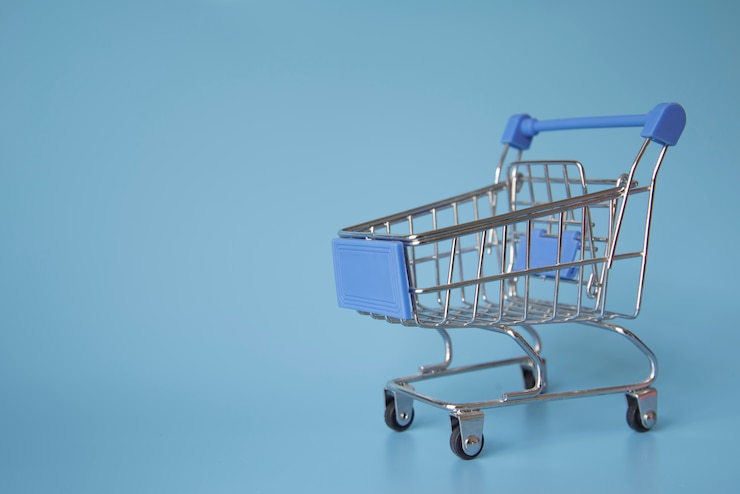 Foto gratuito miniatura del carrito de compras