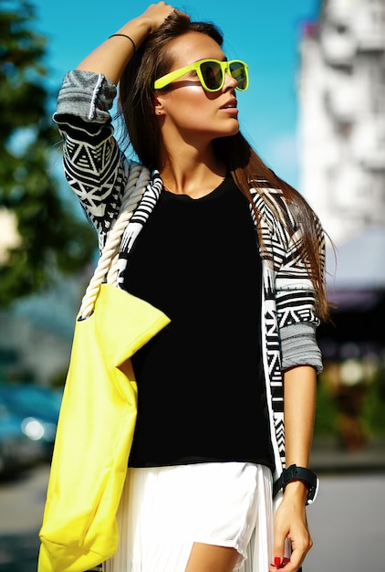 Moda elegante hermosa morena joven modelo en verano hipster ropa casual colorida posando en el fondo de la calle