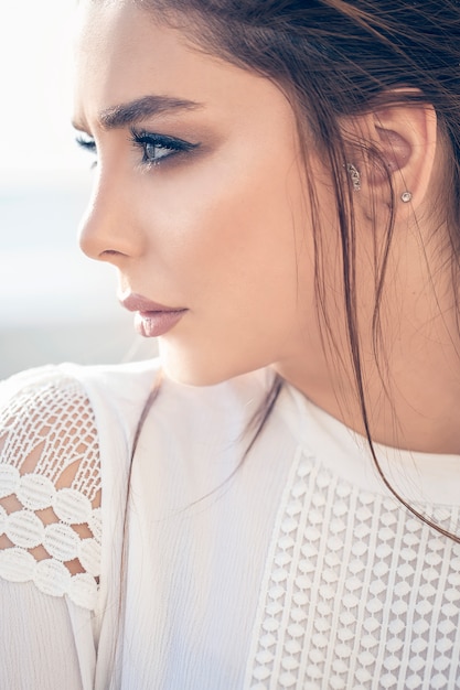 Modelo femenino en maquillaje de otoño invierno y camisa blanca