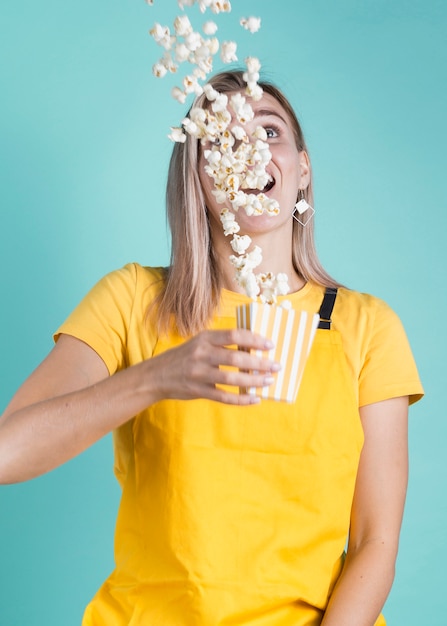 Foto gratuita modelo de tiro medio de palomitas de maíz deslizándose