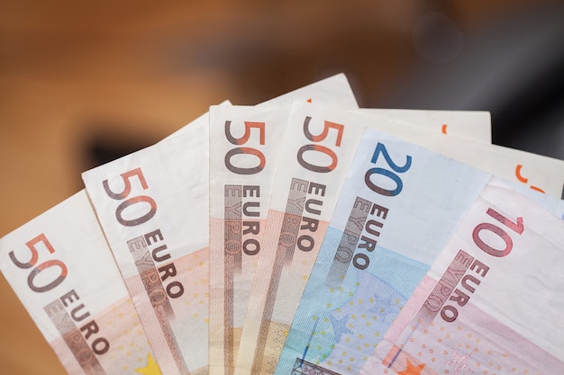 Montón de billetes en euros en una mesa de madera