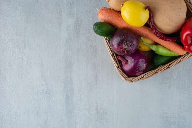 Montón de diversas verduras en canasta de madera.