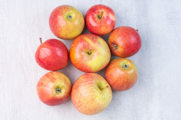 Un montón de manzana roja fresca, sobre el mármol.