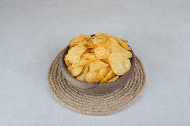 Montón de patatas fritas crujientes en un tazón de madera