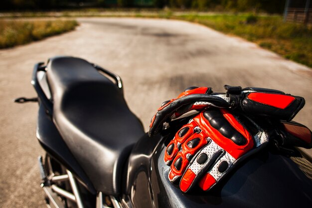 Moto negra con guantes rojos