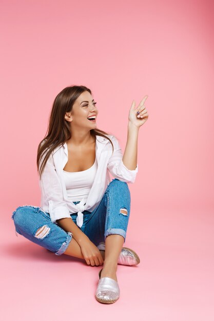 Muchacha divertida en ropa fresca sonriendo y mirando a otro lado