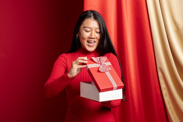 Mujer abriendo la caja de regalo para el año nuevo chino