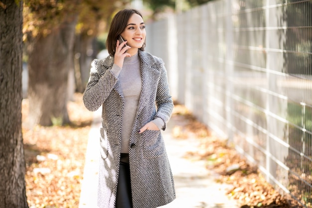 Mujer en abrigo con teléfono