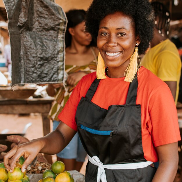 Mujer africana sonriente trabajando en el mercado