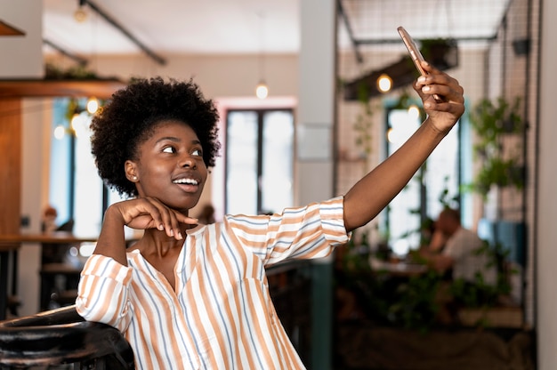 Mujer afroamericana tomando un selfie con su smartphone