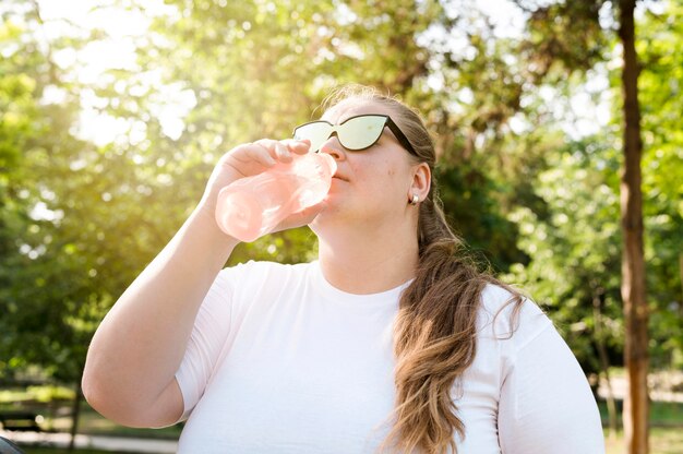 Mujer, agua potable, en el parque