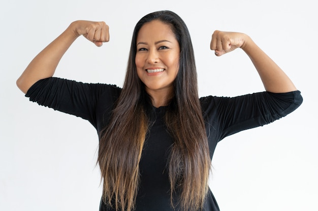 Mujer alegre de mediana edad demostrando poder.