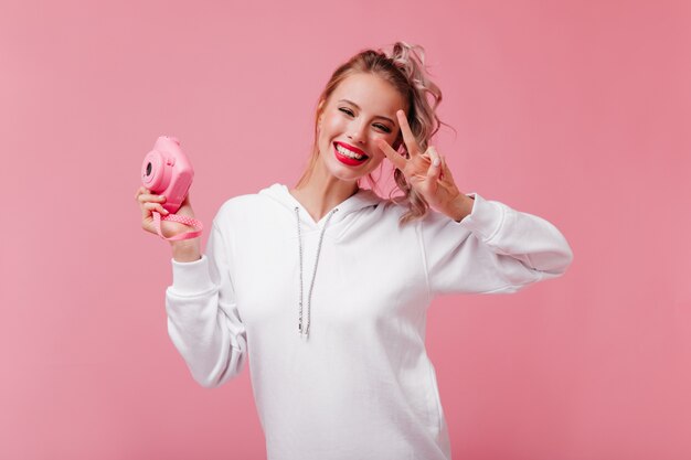 Mujer alegre posando con el signo de la paz