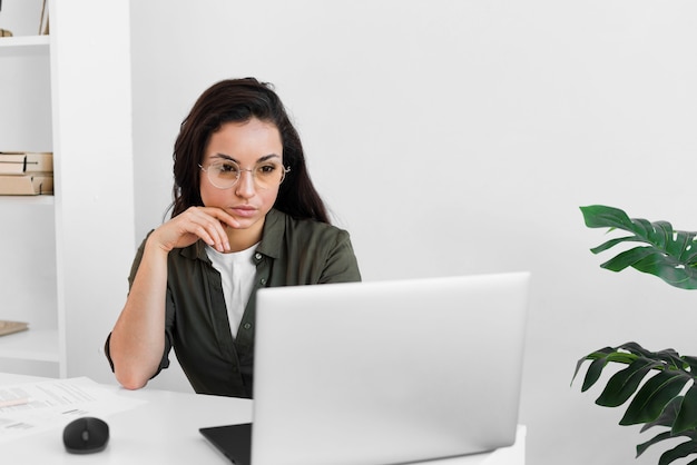 Mujer de alto ángulo que trabaja en la computadora portátil