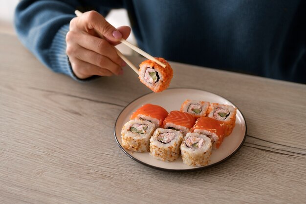 Mujer de alto ángulo sosteniendo sushi