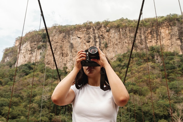 Foto gratuita mujer de ángulo bajo en la naturaleza tomando fotos