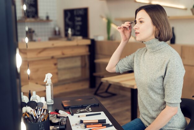 Mujer aplicando maquillaje de cejas