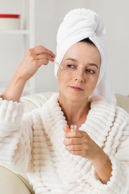 Mujer aplicar crema hidratante en el rostro