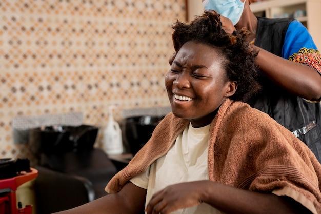 Foto gratuita mujer arreglando su cabello en el salón