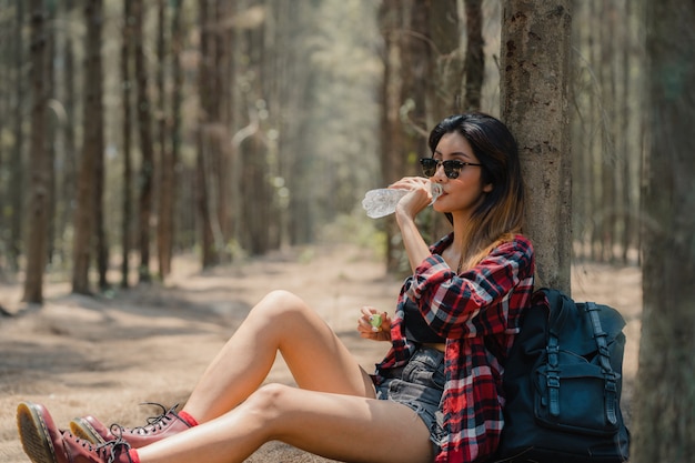 Mujer asiática excursionista trekking en bosque.