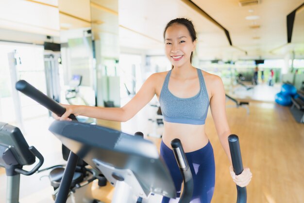 La mujer asiática del retrato que ejercita y se resuelve en gimnasio