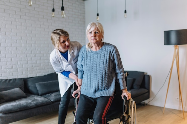 Foto gratuita mujer en asilo de ancianos con silla de ruedas