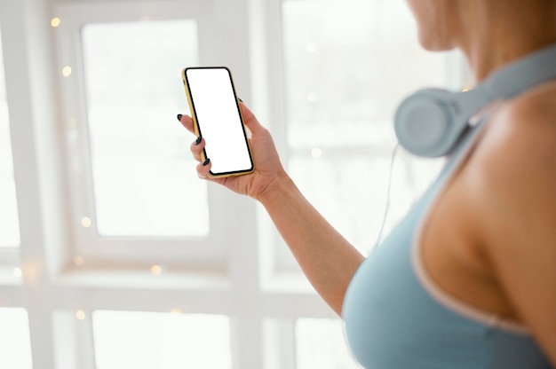 Mujer con auriculares mediante teléfono