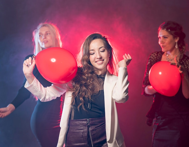 Mujer bailando mientras hoding globos