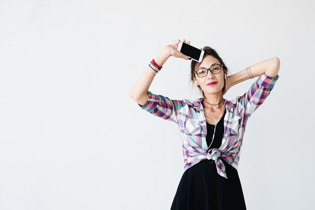 mujer bailando y mostrando el teléfono