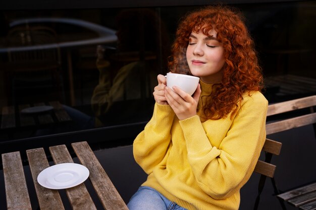 Mujer bebiendo chocolate caliente en el cafe