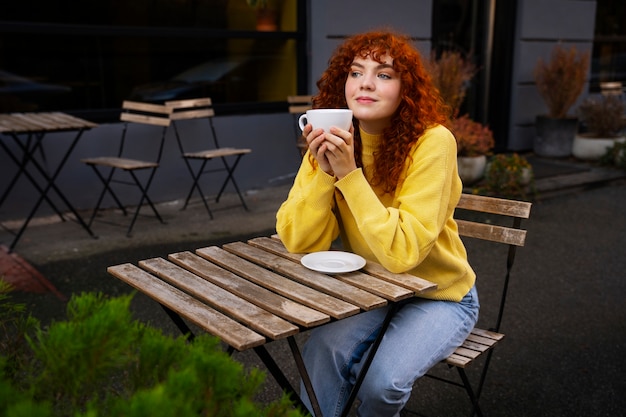 Mujer bebiendo chocolate caliente en el cafe
