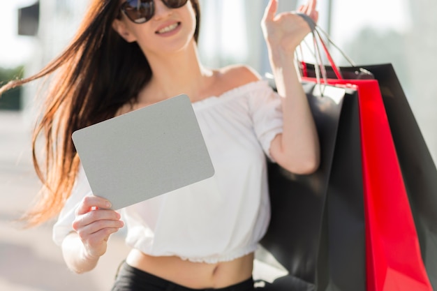 Mujer con bolsas de compras y banner vacío