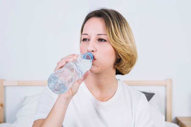 Mujer bonita bebiendo agua de botella
