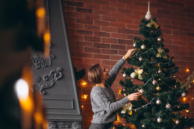 Foto gratuita mujer bonita, decorar el árbol de navidad