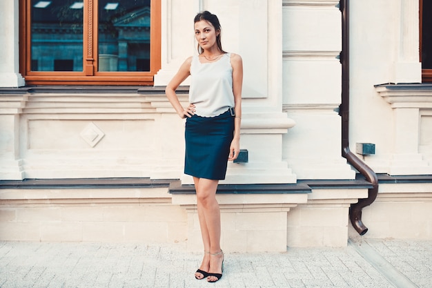 Foto gratuita mujer bonita de moda caminando por las calles de la ciudad vieja